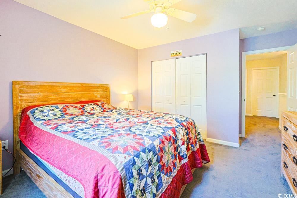 2033 Chadbury Lane Myrtle Beach, SC 29588 - Photo 24 of 39 Bedroom featuring light carpet, a ceiling fan, and a closet