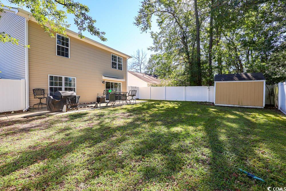 2033 Chadbury Lane Myrtle Beach, SC 29588 - Photo 31 of 39 Fenced backyard featuring a storage shed and a patio