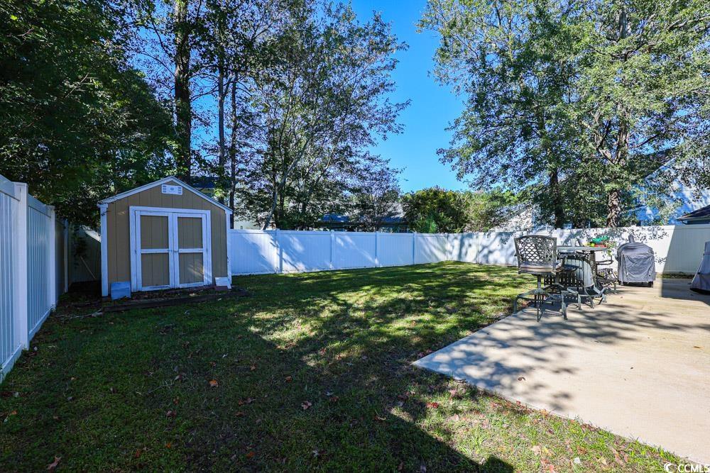 2033 Chadbury Lane Myrtle Beach, SC 29588 - Photo 32 of 39 Fenced backyard featuring a storage shed and a patio