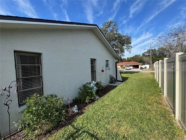a backyard of a house with plants and outdoor space