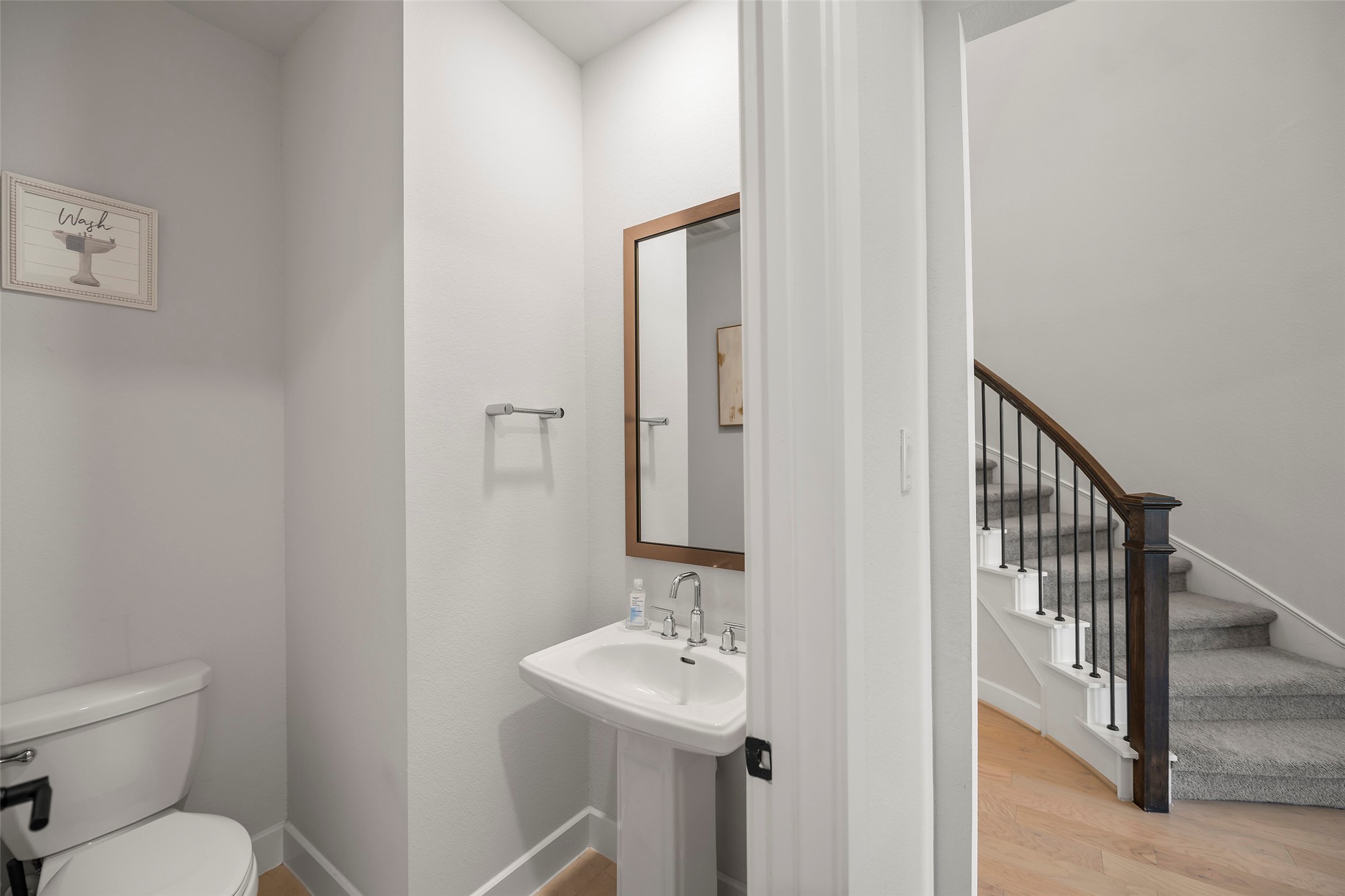 4802 Pecos Ridge Lane Sugar Land, TX 77479 - Photo 20 of 32 a bathroom with a toilet a sink and mirror