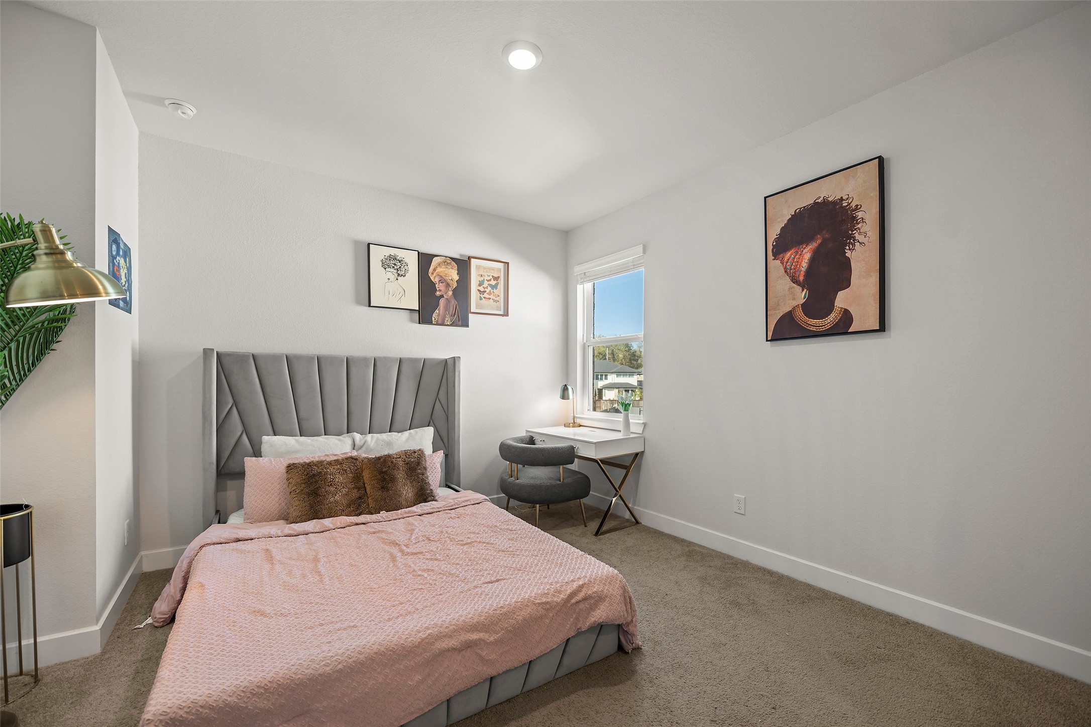 4802 Pecos Ridge Lane Sugar Land, TX 77479 - Photo 21 of 32 a bedroom with bed and paintings on the wall