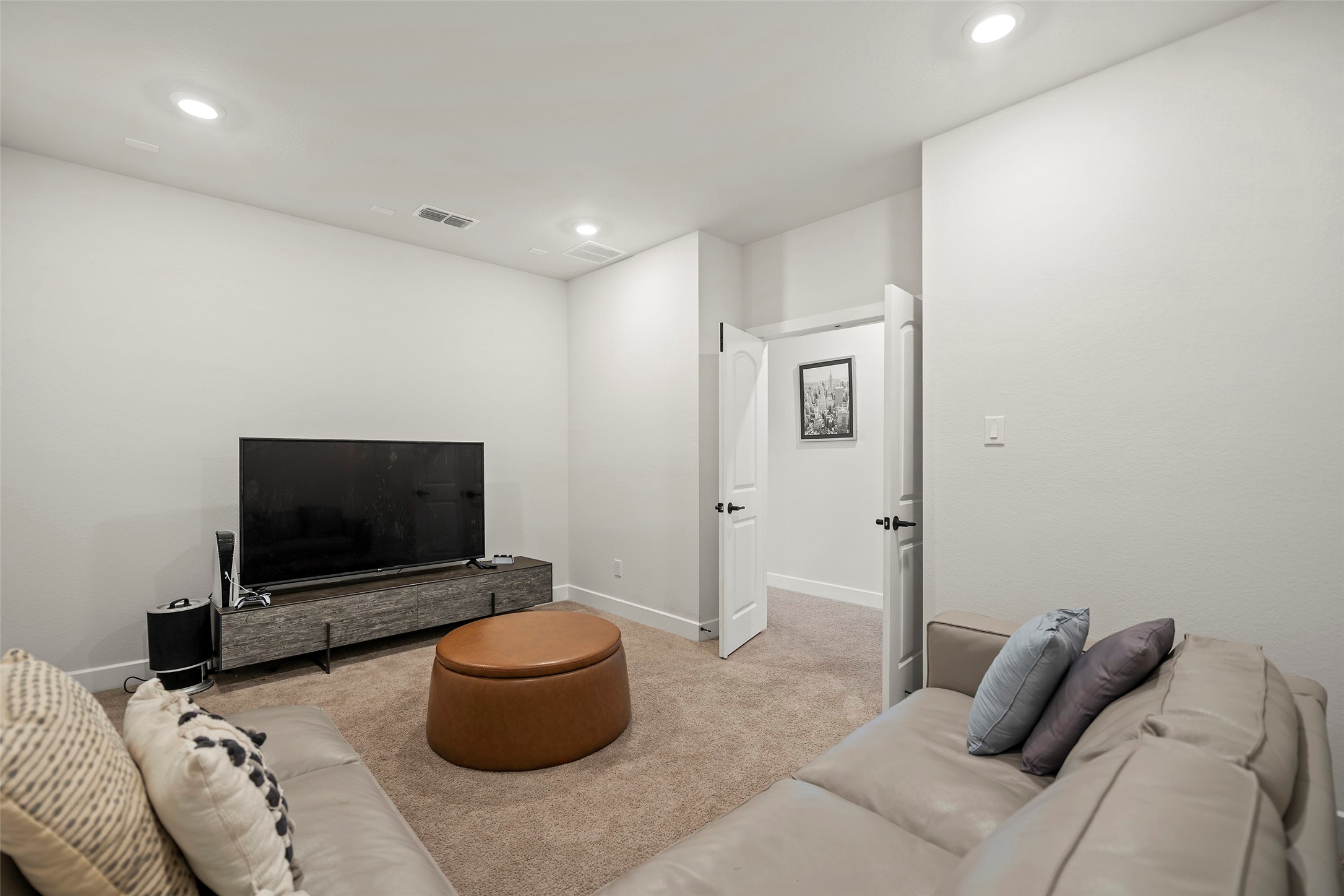 4802 Pecos Ridge Lane Sugar Land, TX 77479 - Photo 25 of 32 a living room with furniture and a flat screen tv