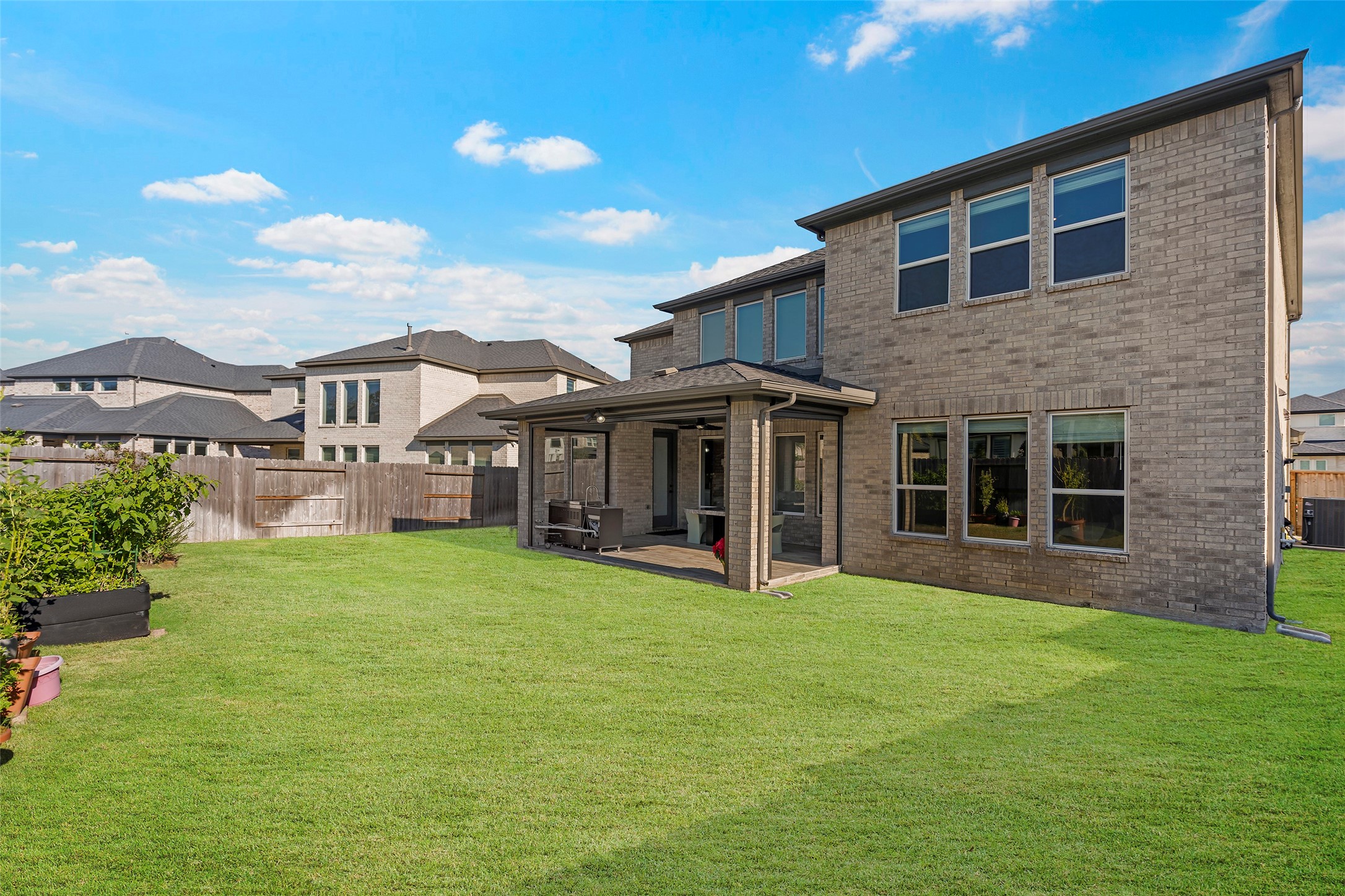 4802 Pecos Ridge Lane Sugar Land, TX 77479 - Photo 28 of 32 a view of a house with a yard and sitting area