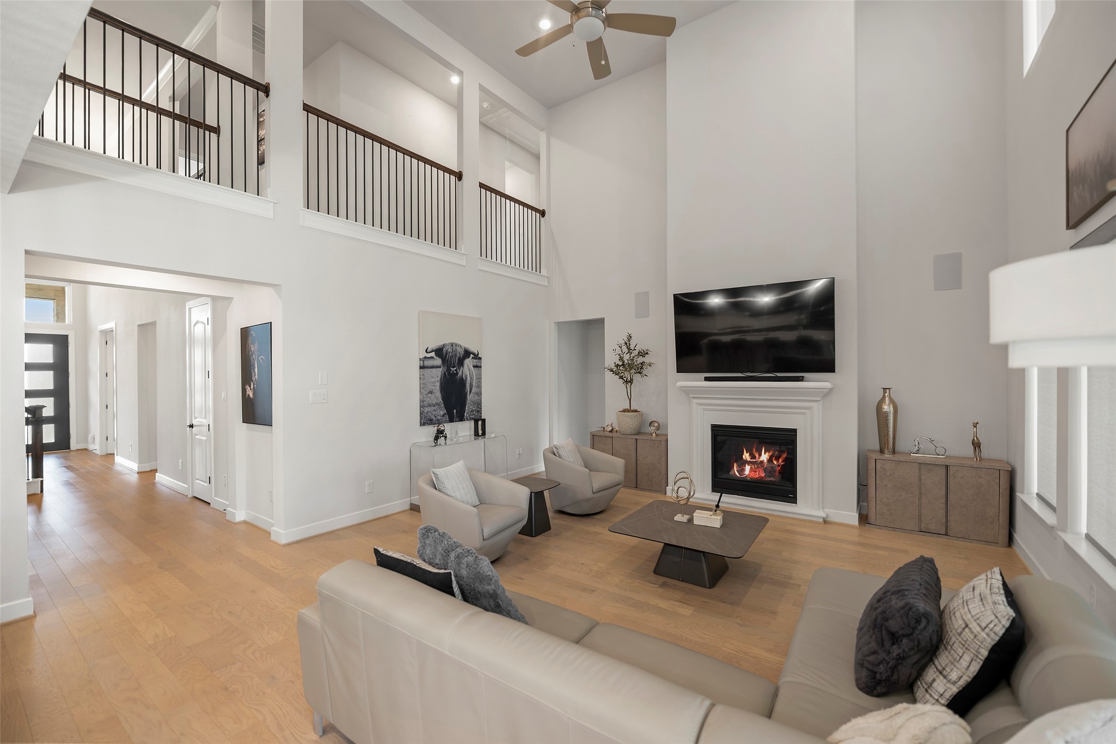 4802 Pecos Ridge Lane Sugar Land, TX 77479 - Photo 4 of 32 a living room with furniture a fireplace and a flat screen tv