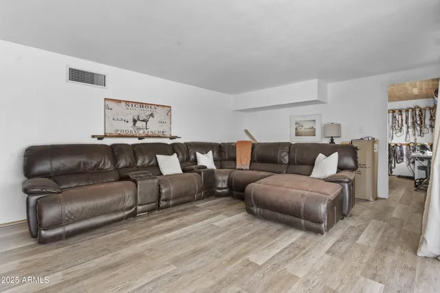 a en suite bathroom with a granite countertop sink and a mirror