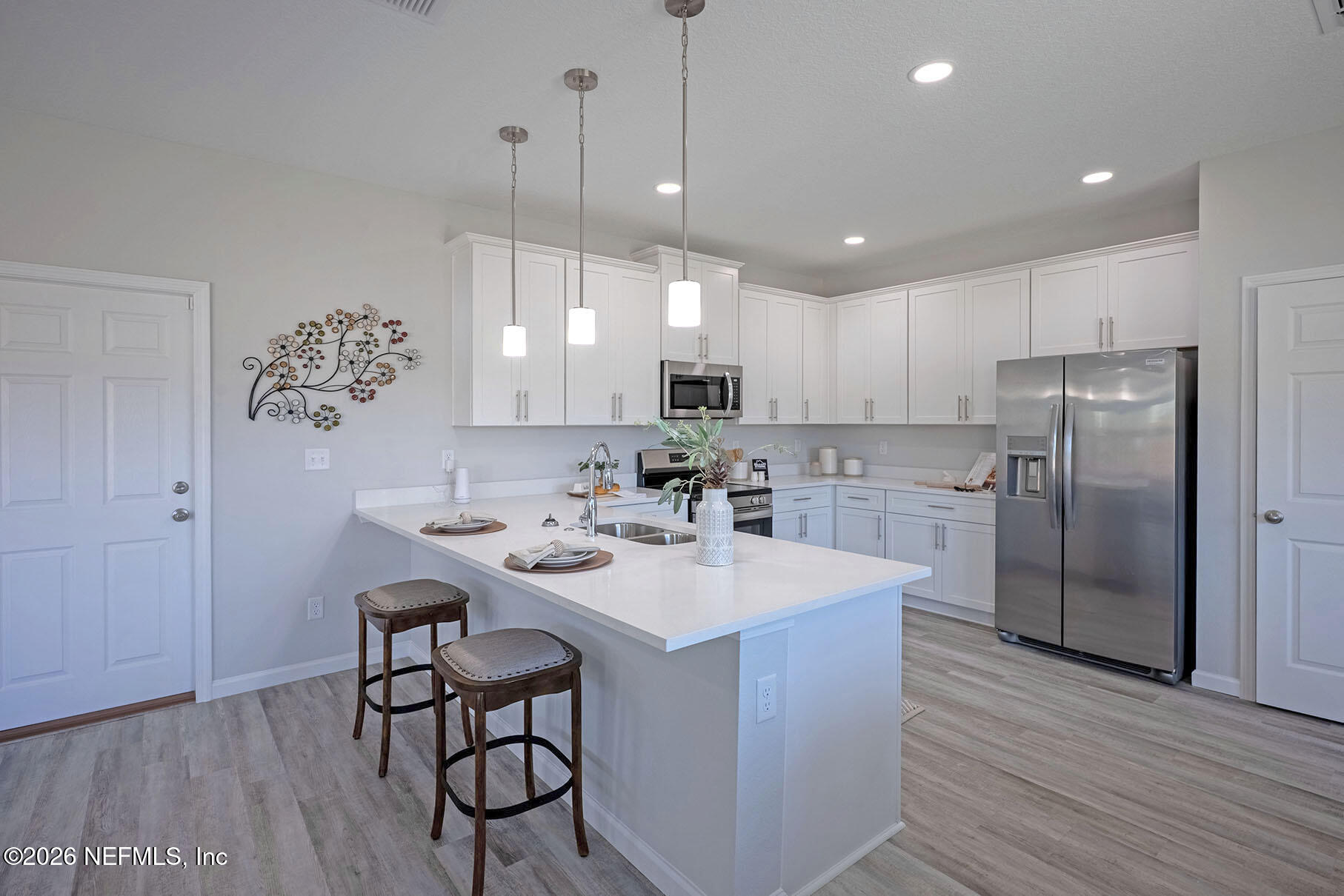 1218 Jewelstone Lane Jacksonville, FL 32221 - Photo 12 of 53 a kitchen with stainless steel appliances granite countertop a sink a stove a refrigerator and island with wooden floor