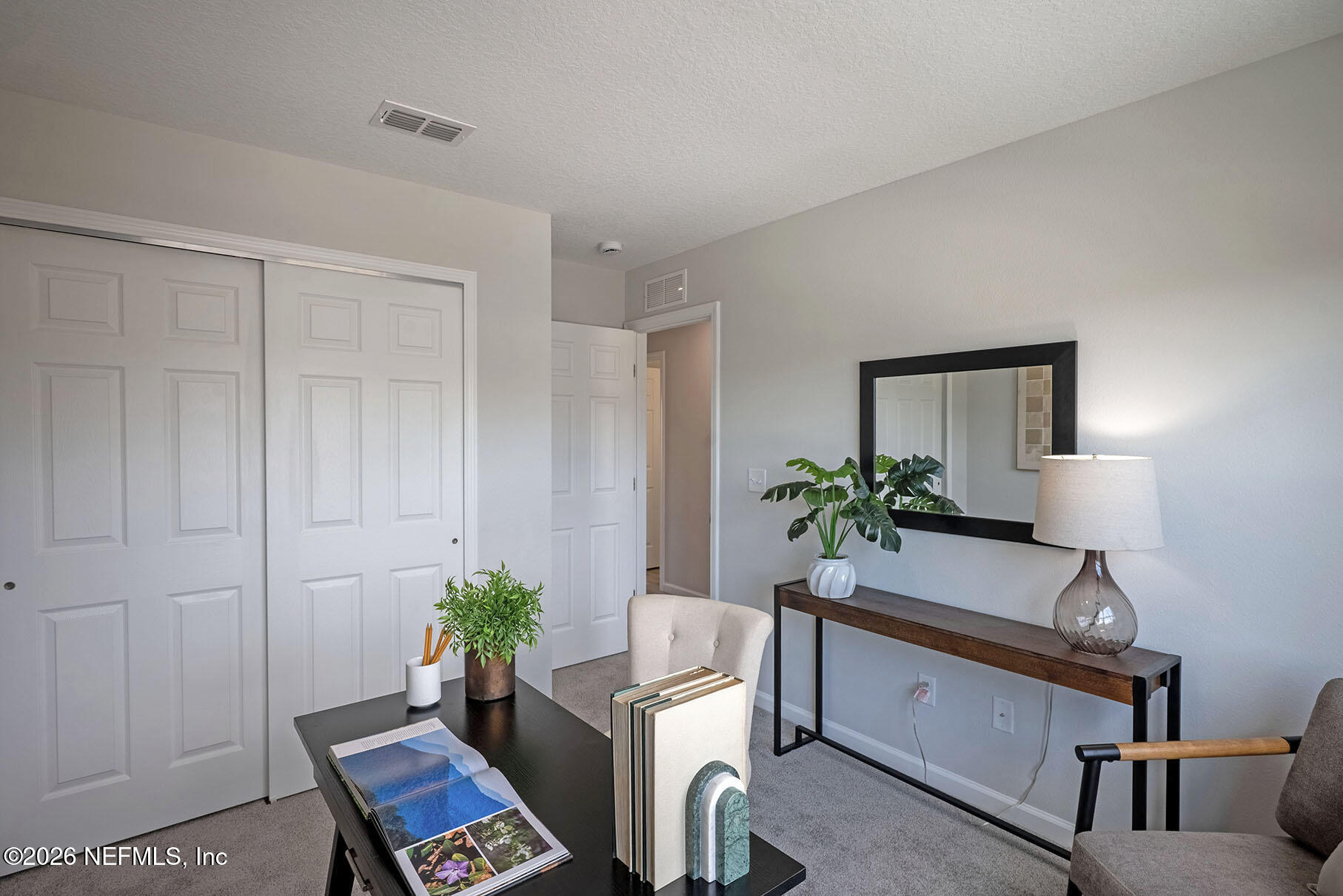 1218 Jewelstone Lane Jacksonville, FL 32221 - Photo 35 of 53 a room with furniture a potted plant and a lamp