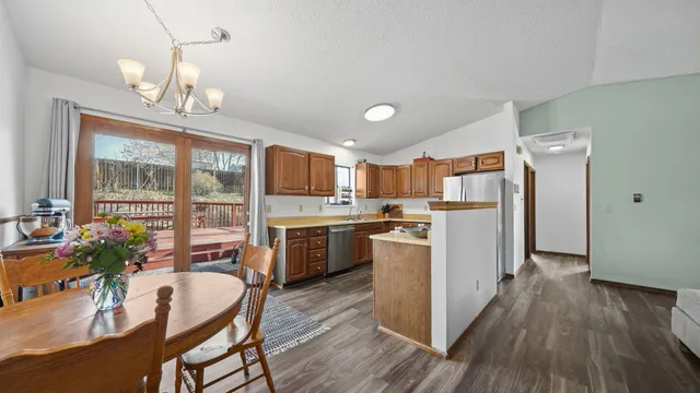 a kitchen with refrigerator cabinets dining table and chairs