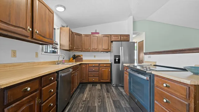 a kitchen with a sink stove and refrigerator
