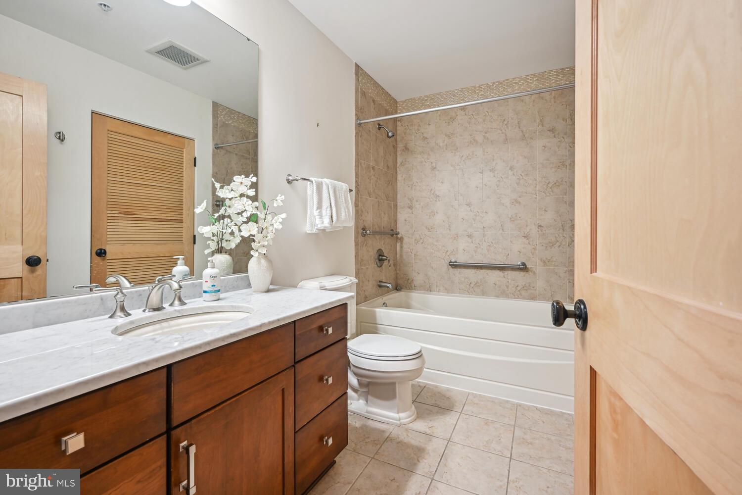 9610 Dewitt Drive, Unit B414 Silver Spring, MD 20910 - Photo 10 of 31 Hall bath, marble countertop, custom tiled shower