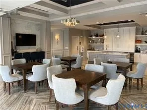 a dining room with furniture a large window and a fireplace
