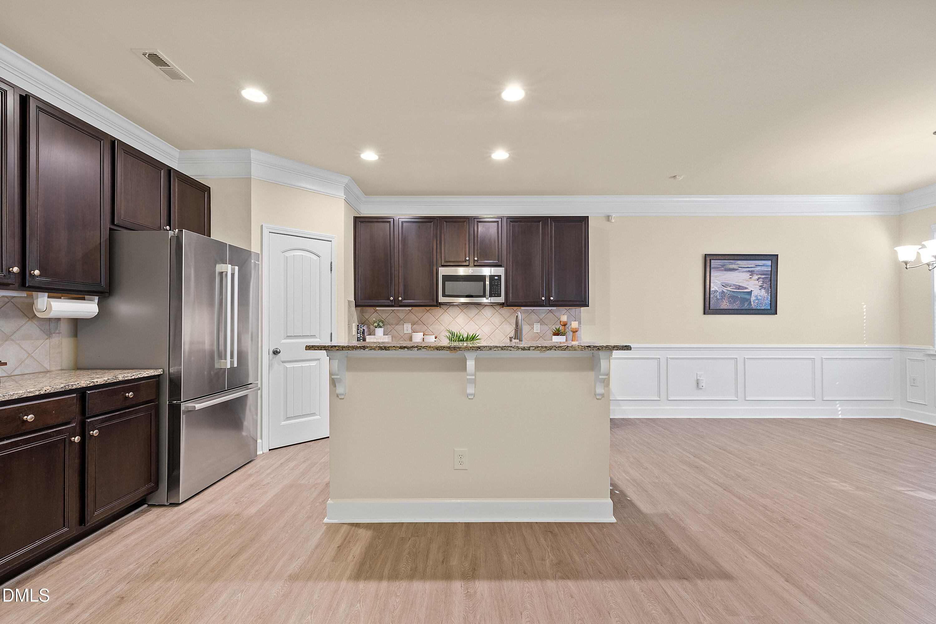 2063 Weston Green Loop Cary, NC 27513 - Photo 16 of 40 a kitchen with stainless steel appliances granite countertop a stove a sink dishwasher a refrigerator and white cabinets with wooden floor