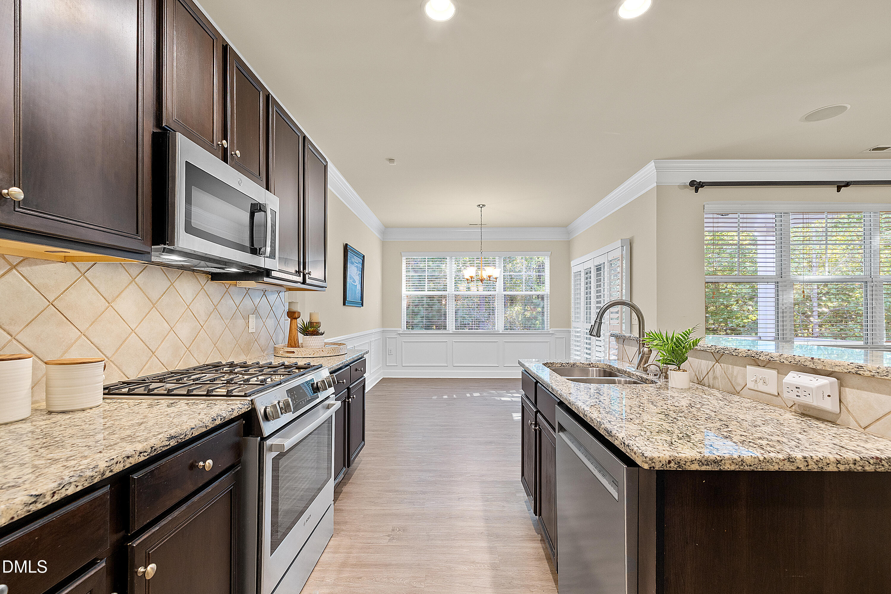 2063 Weston Green Loop Cary, NC 27513 - Photo 18 of 40 a kitchen with granite countertop stainless steel appliances a sink stove and cabinets