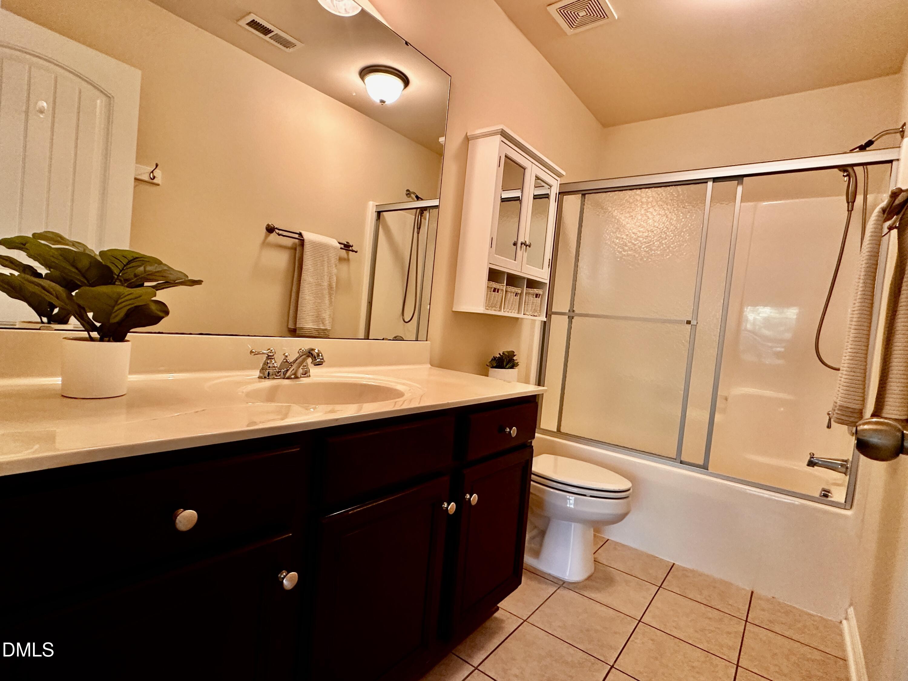 2063 Weston Green Loop Cary, NC 27513 - Photo 26 of 40 a bathroom with a sink toilet and shower