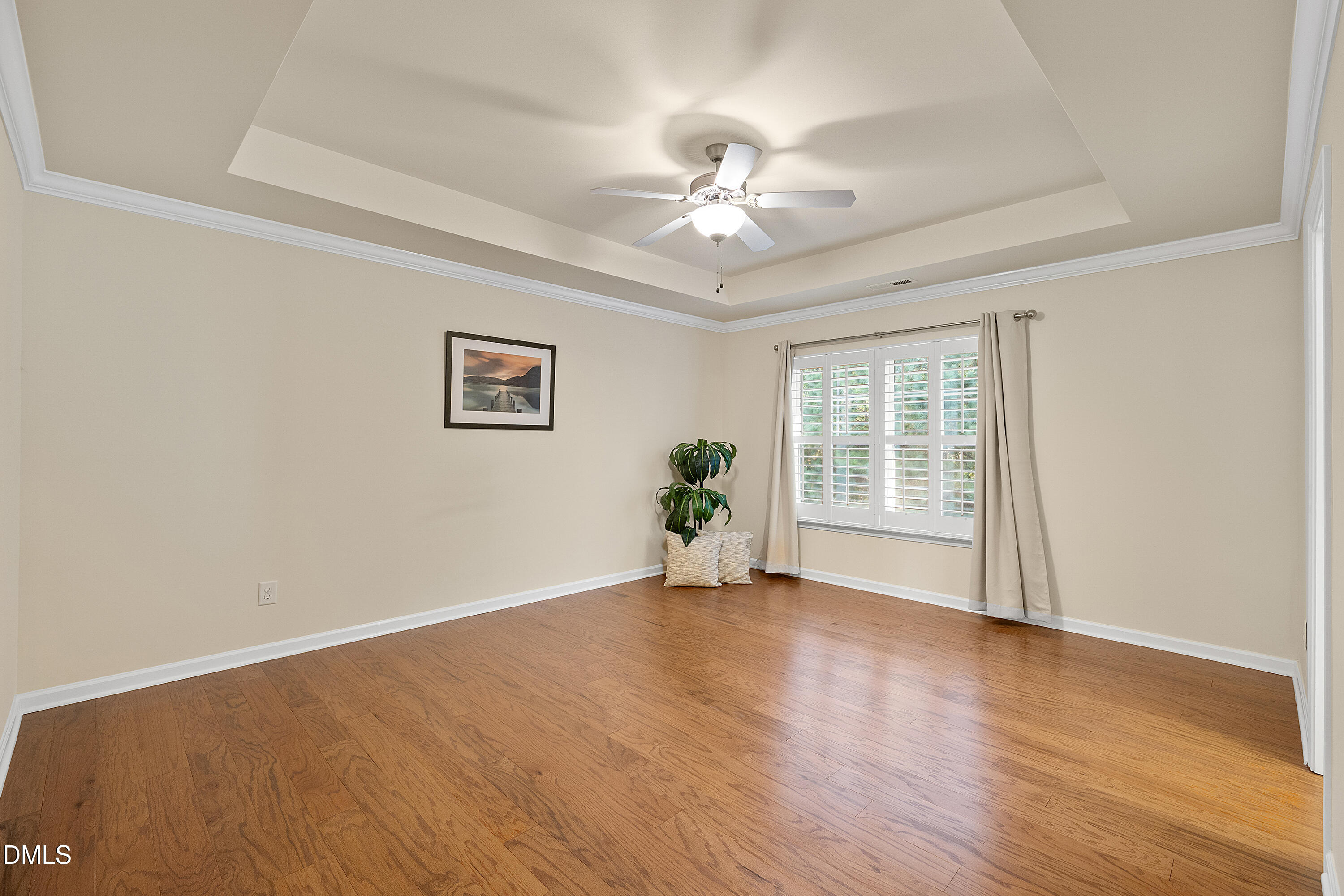 2063 Weston Green Loop Cary, NC 27513 - Photo 28 of 40 a view of an empty room with wooden floor and a window