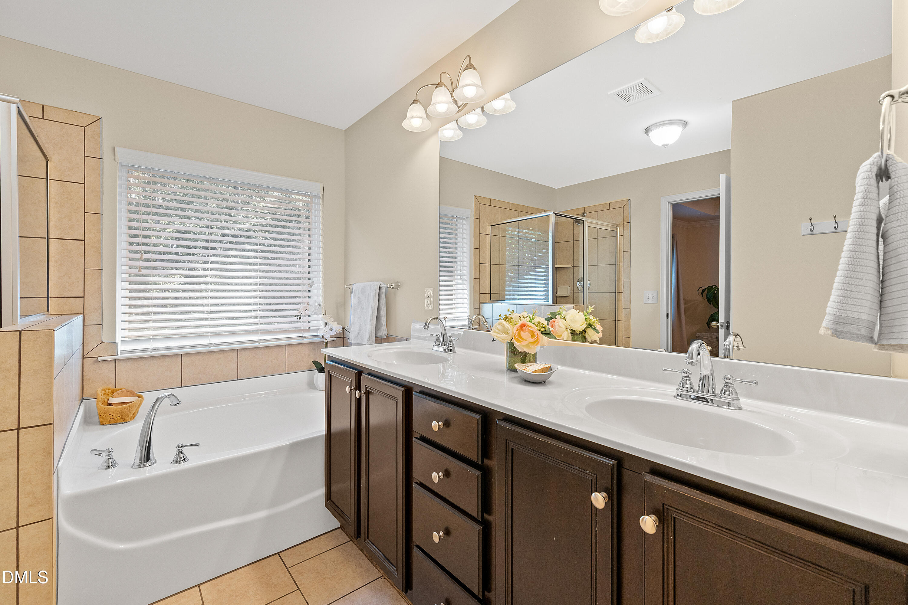 2063 Weston Green Loop Cary, NC 27513 - Photo 31 of 40 a bathroom with a granite countertop sink mirror bathtub and next to a window
