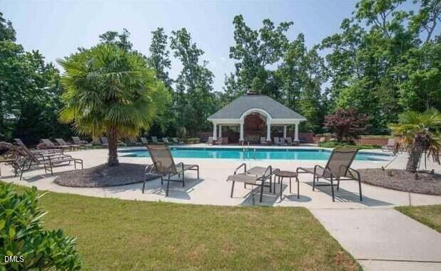 2063 Weston Green Loop Cary, NC 27513 - Photo 36 of 40 a view of a white house with a yard patio and swimming pool