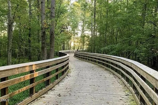 a view of a white house with a yard patio and swimming pool
