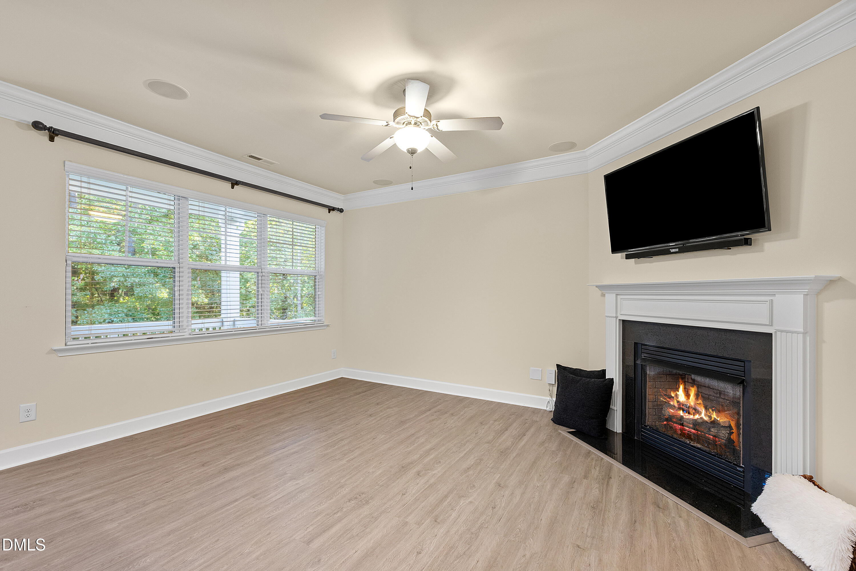 2063 Weston Green Loop Cary, NC 27513 - Photo 3 of 40 a view of an empty room with wooden floor fireplace and a window
