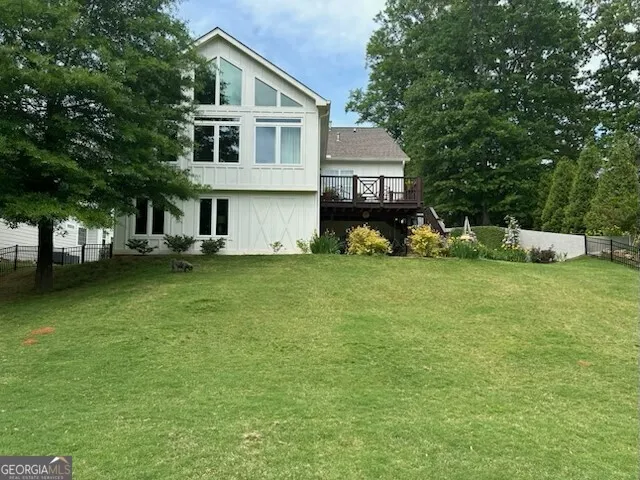 a front view of a house with a yard and trees