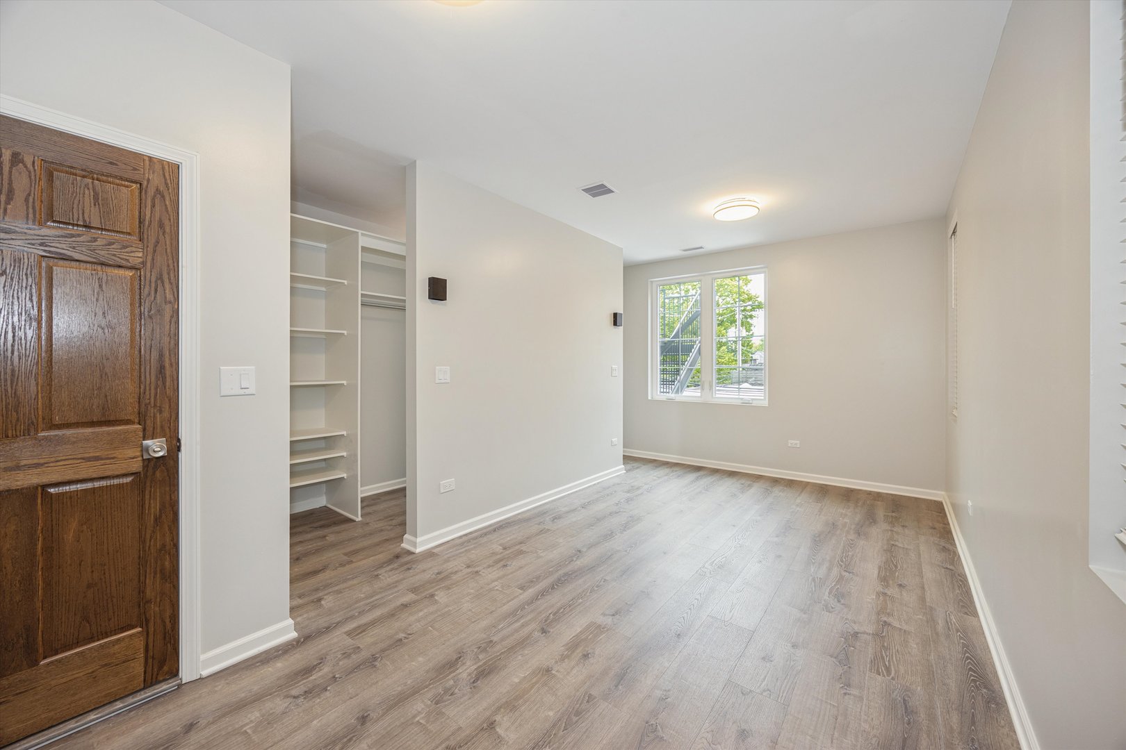 2008 West Addison Street, Unit 2 Chicago, IL 60618 - Photo 13 of 19 an empty room with wooden floor closet and windows