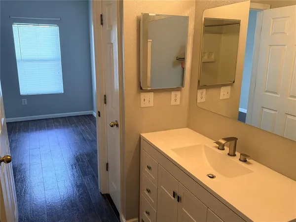 a bathroom with a tub sink and mirror