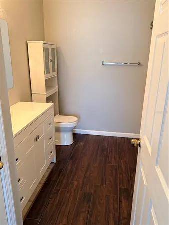 a bathroom with a sink a toilet and a mirror