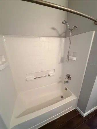 a bathroom with a bathtub and shower