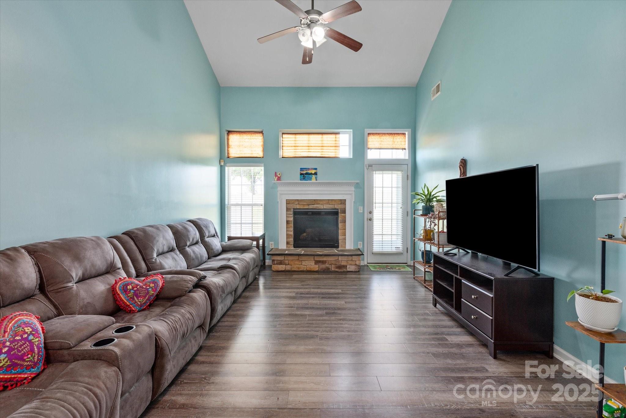1498 Burrell Avenue Northwest Concord, NC 28027 - Photo 11 of 35 a living room with furniture flat screen tv and a fireplace