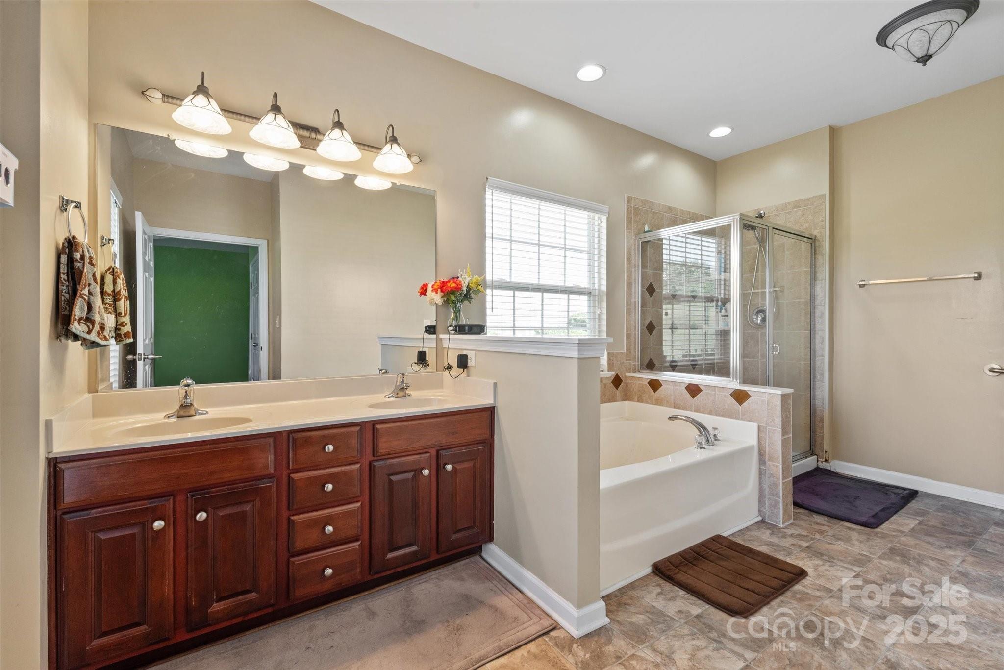 1498 Burrell Avenue Northwest Concord, NC 28027 - Photo 16 of 35 a spacious bathroom with a tub sink and mirror