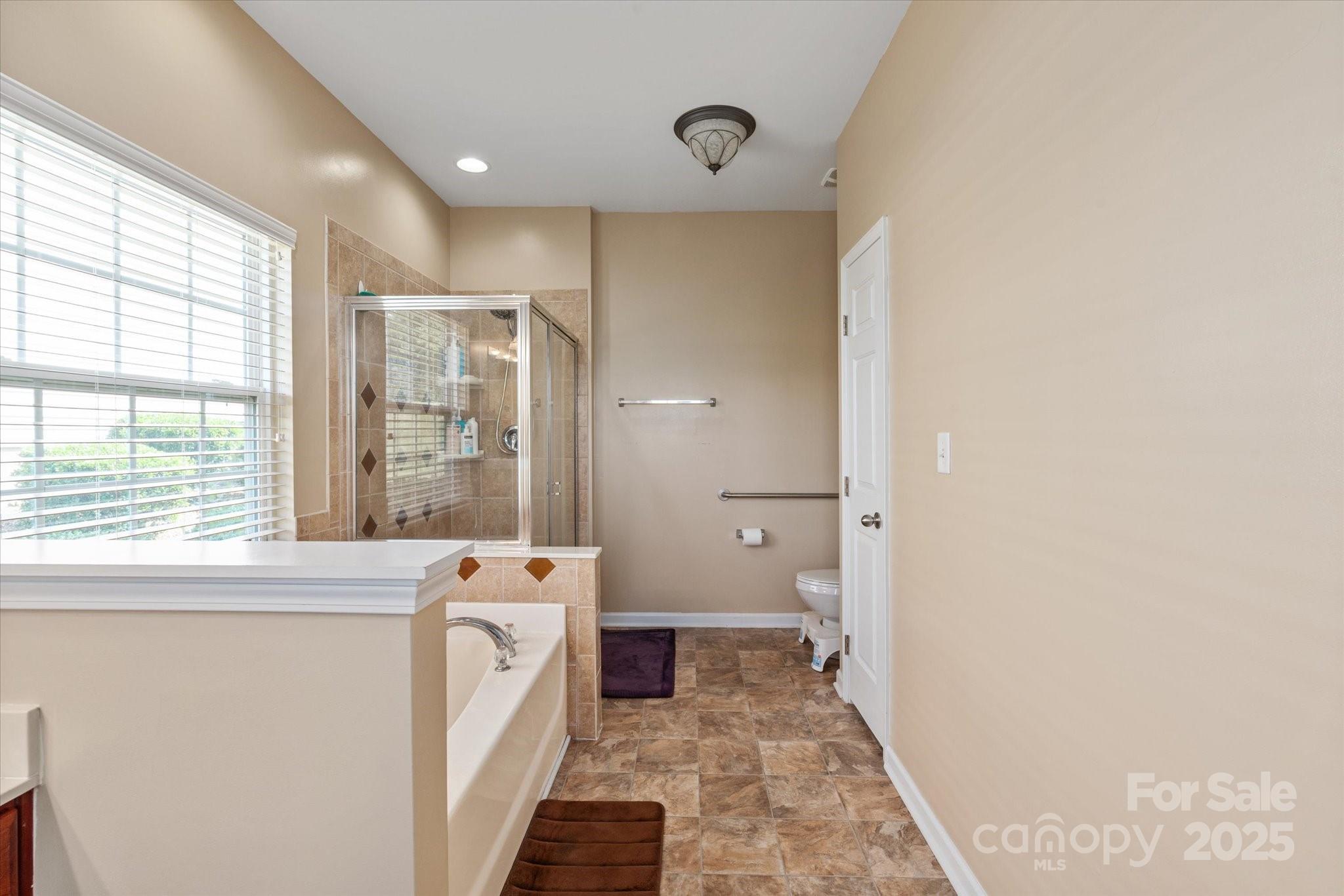 1498 Burrell Avenue Northwest Concord, NC 28027 - Photo 17 of 35 a view of a bathroom with a sink and a large window