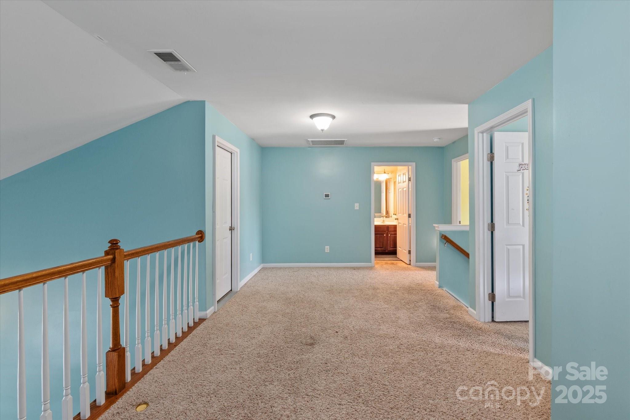 1498 Burrell Avenue Northwest Concord, NC 28027 - Photo 20 of 35 a view of a hallway with wooden floor and a bathroom