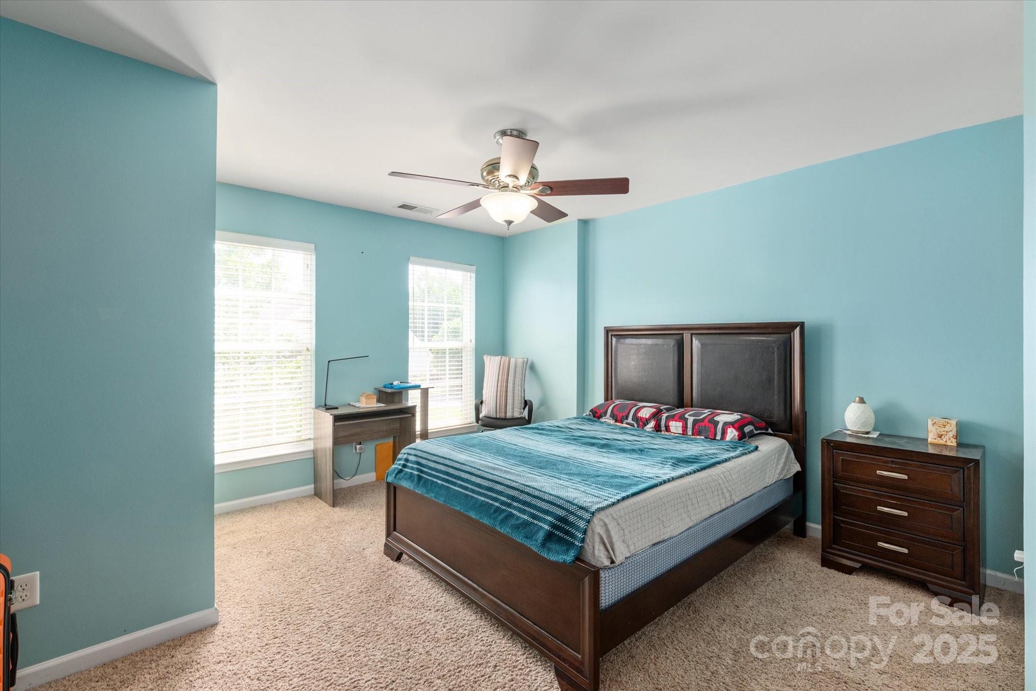 1498 Burrell Avenue Northwest Concord, NC 28027 - Photo 21 of 35 a bedroom with a bed and a table