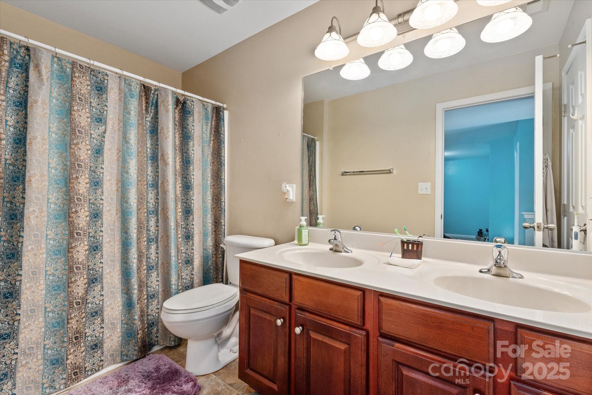 1498 Burrell Avenue Northwest Concord, NC 28027 - Photo 24 of 35 a bathroom with a double vanity sink mirror and toilet