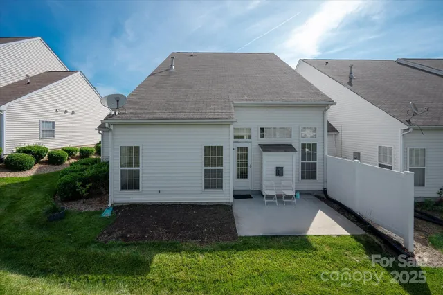 a aerial view of a house next to a big yard and large trees