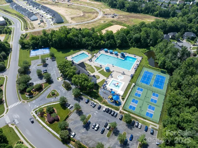 an aerial view of a house a yard swimming pool and outdoor seating