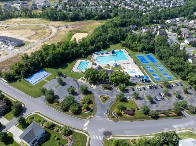 an aerial view of residential house with outdoor space and swimming pool