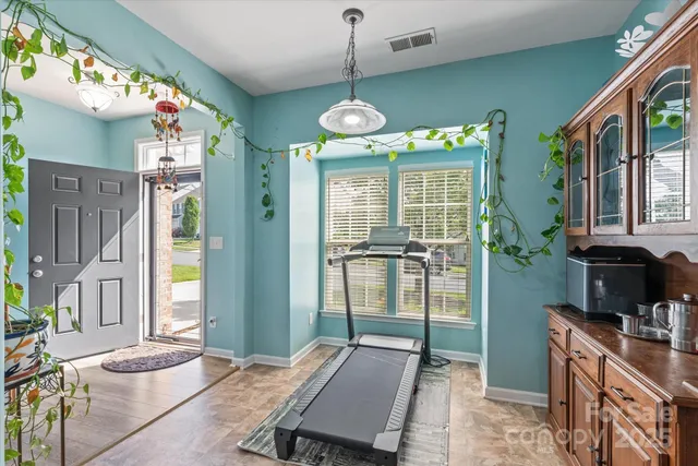 a room with musical instrument pool table and windows