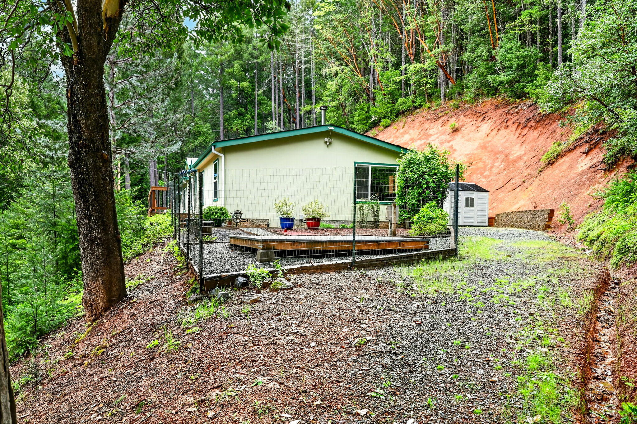 5445 Thompson Creek Road Selma, OR 97538 - Photo 54 of 57 a backyard of a house with table and chairs
