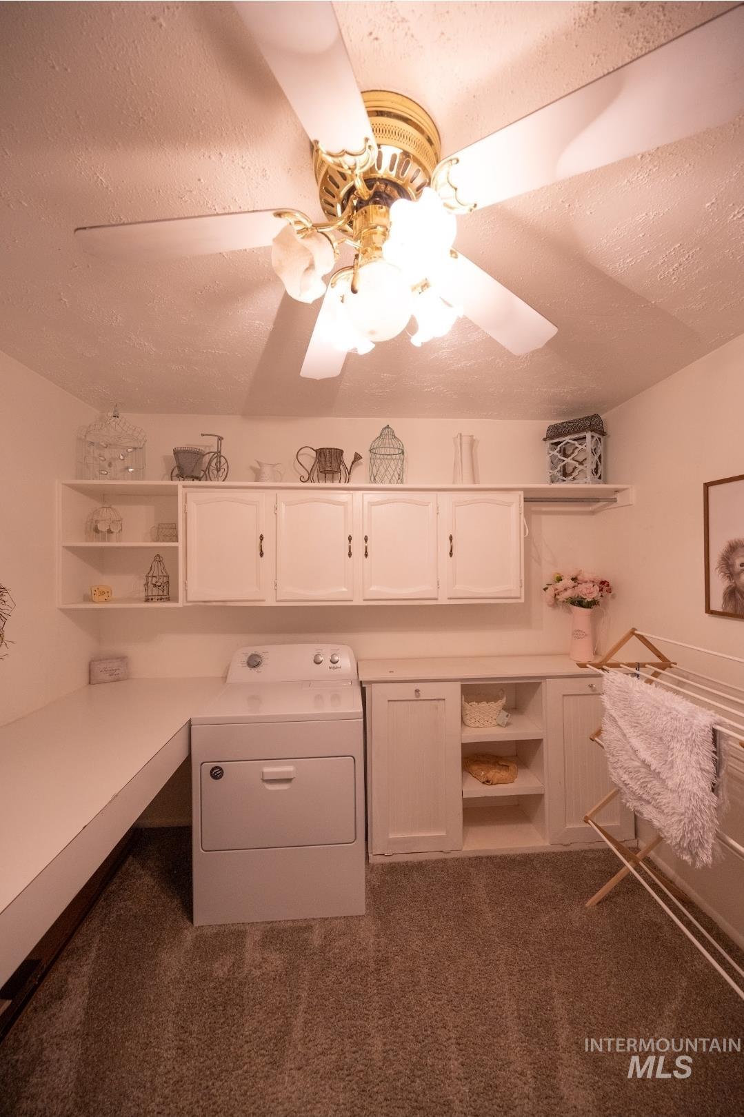 650 West 800 S Road Burley, ID 83318 - Photo 12 of 31 Laundry room featuring washer / dryer, a textured ceiling, dark colored carpet, a desk, and ceiling fan