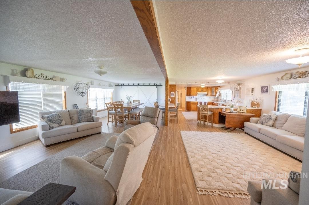650 West 800 S Road Burley, ID 83318 - Photo 17 of 31 Living room featuring a textured ceiling and light wood-style floors