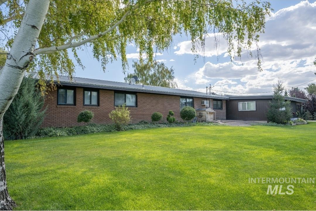 650 West 800 S Road Burley, ID 83318 - Photo 29 of 31 View of front of house with a front lawn, brick siding, and a metal roof