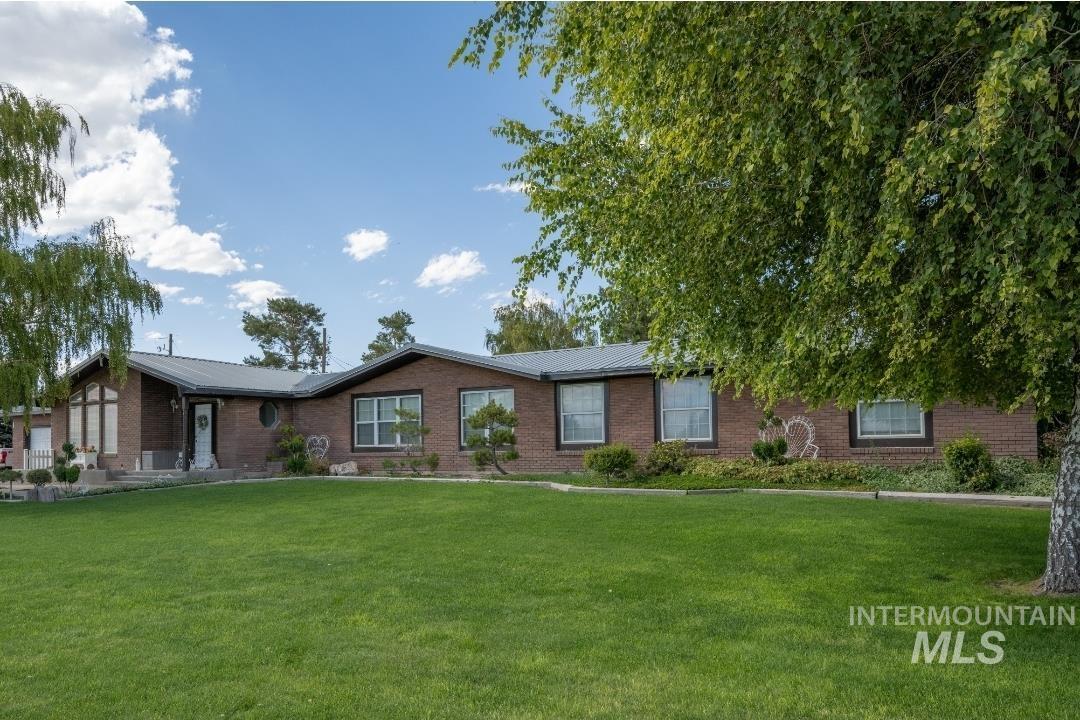 650 West 800 S Road Burley, ID 83318 - Photo 30 of 31 Ranch-style home with brick siding, a metal roof, and a front lawn