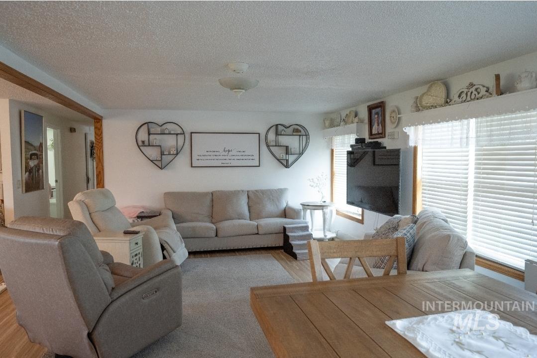 650 West 800 S Road Burley, ID 83318 - Photo 9 of 31 Living area with a textured ceiling and wood finished floors