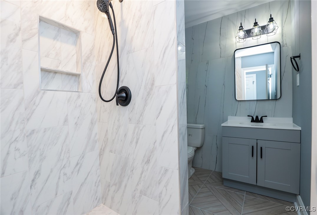 1130 Berryhill Road Henrico, VA 23231 - Photo 18 of 50 Bathroom with a tile shower, toilet, and vanity
