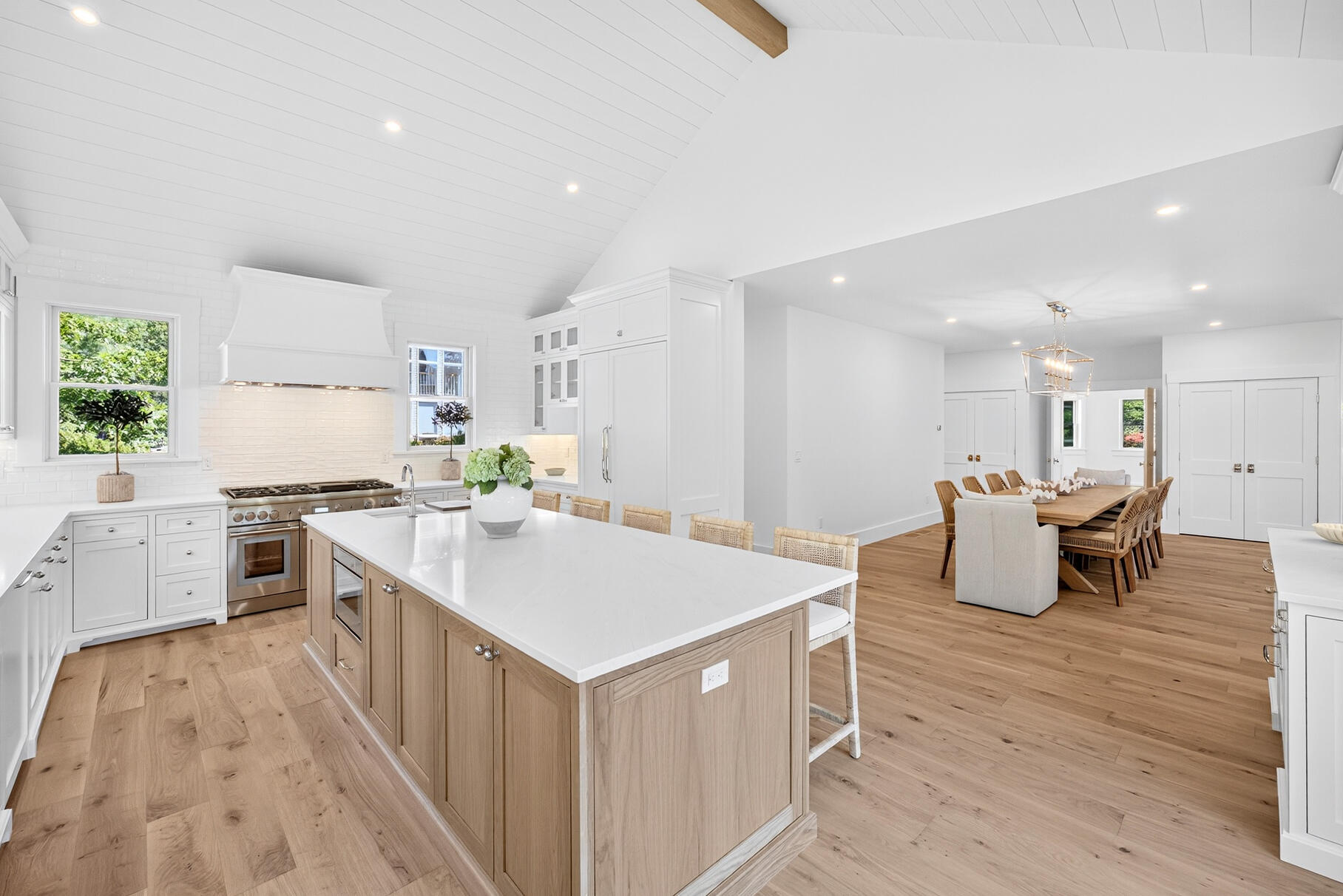 79 Rivers Edge Road East Falmouth, MA 02536 - Photo 21 of 104 a large kitchen with kitchen island a sink dishwasher a stove a dining table and chairs with wooden floor