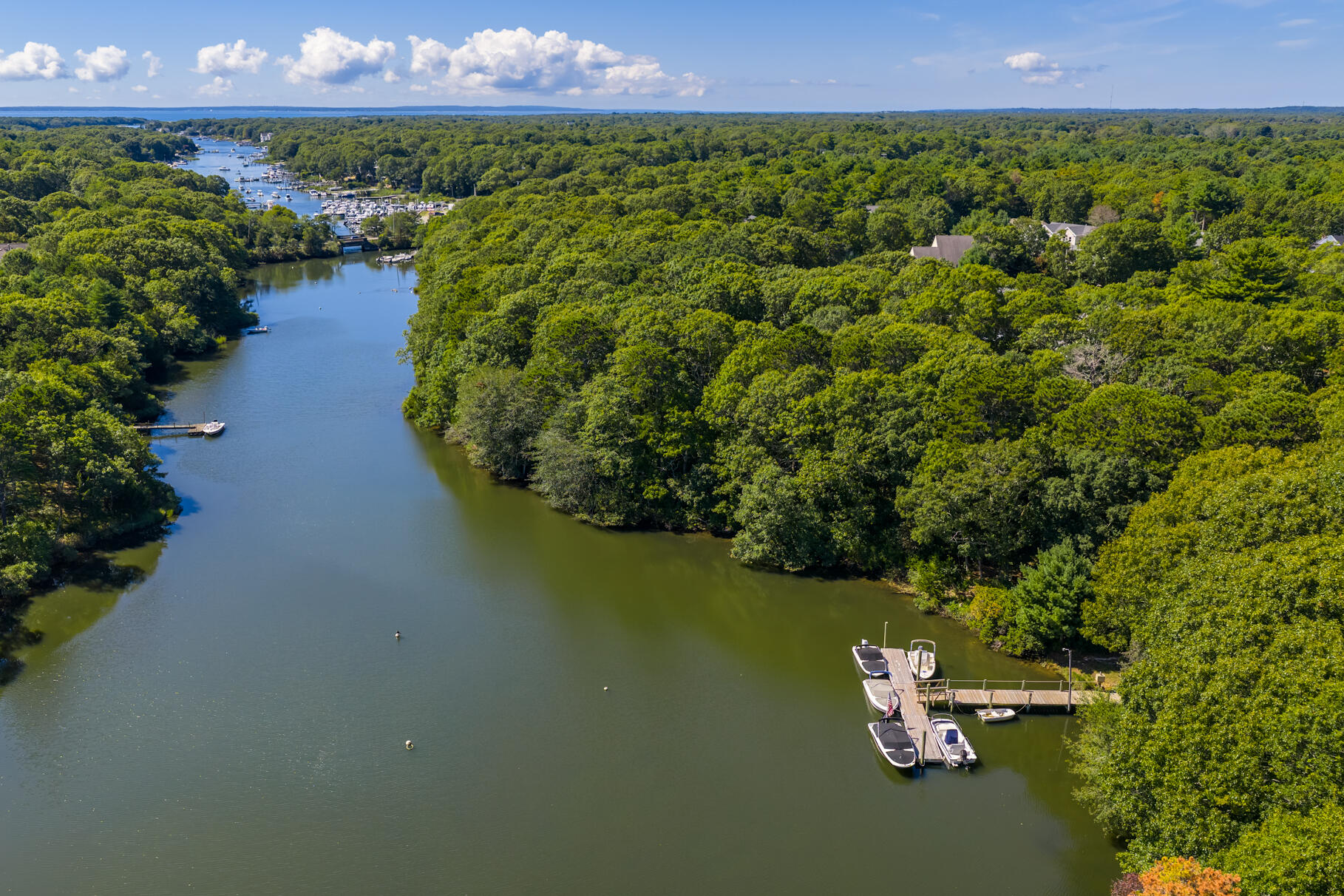 79 Rivers Edge Road East Falmouth, MA 02536 - Photo 79 of 104 a view of a lake with a building in the background