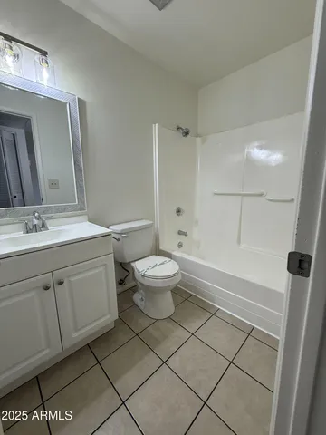 a spacious bathroom with a double vanity sink toilet and shower