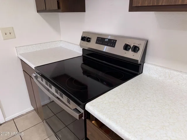 a stove top oven sitting inside of a kitchen